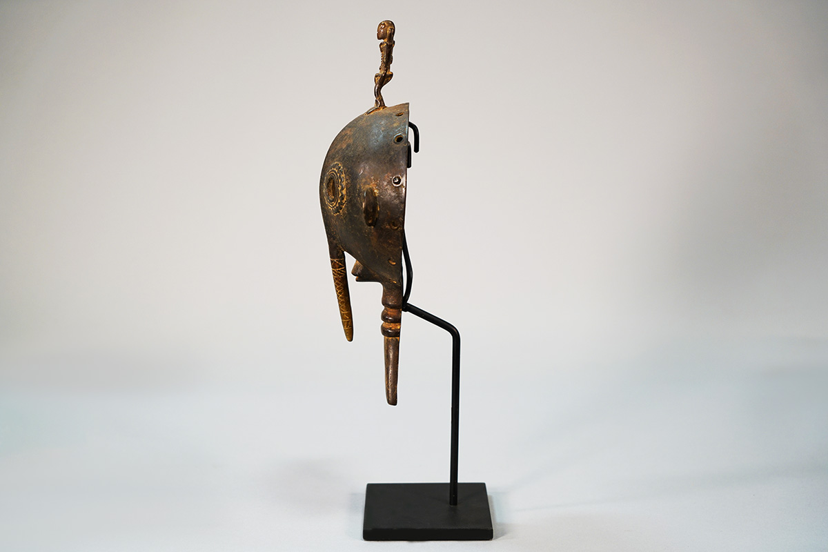 Side view of African face mask on stand