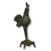 Benin bronze statue of a rooster riding on top of a turtle
